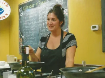 Carol teaching a Greek cooking class
